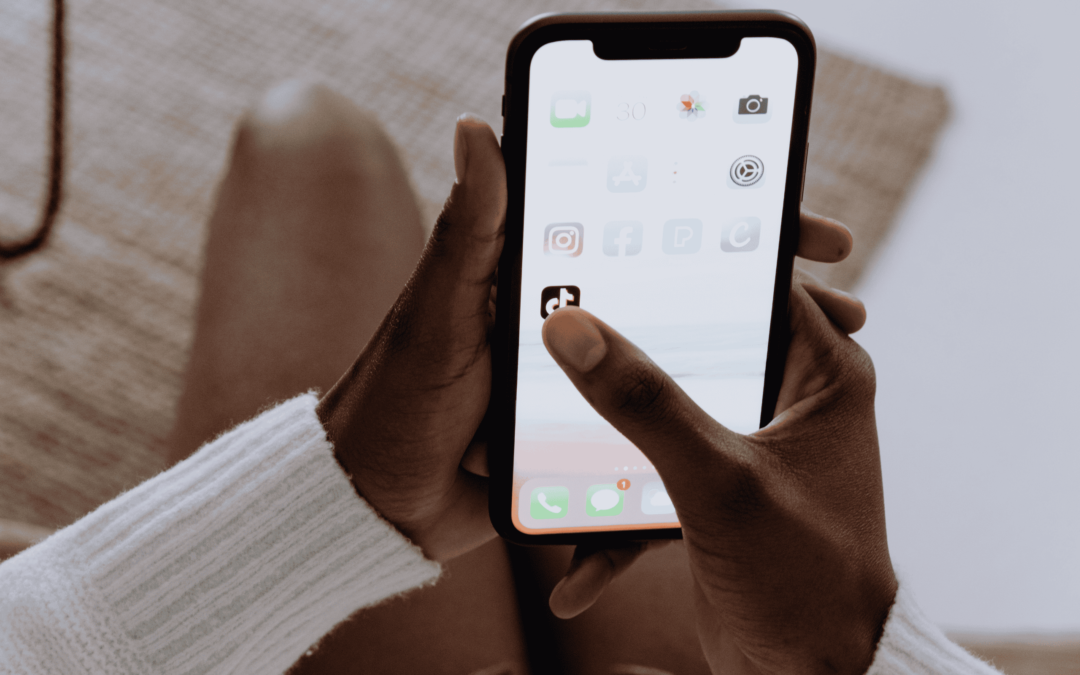 TikTok Marketing Agency - Image of someone clicking the 'TikTok' icon on their iPhone.
