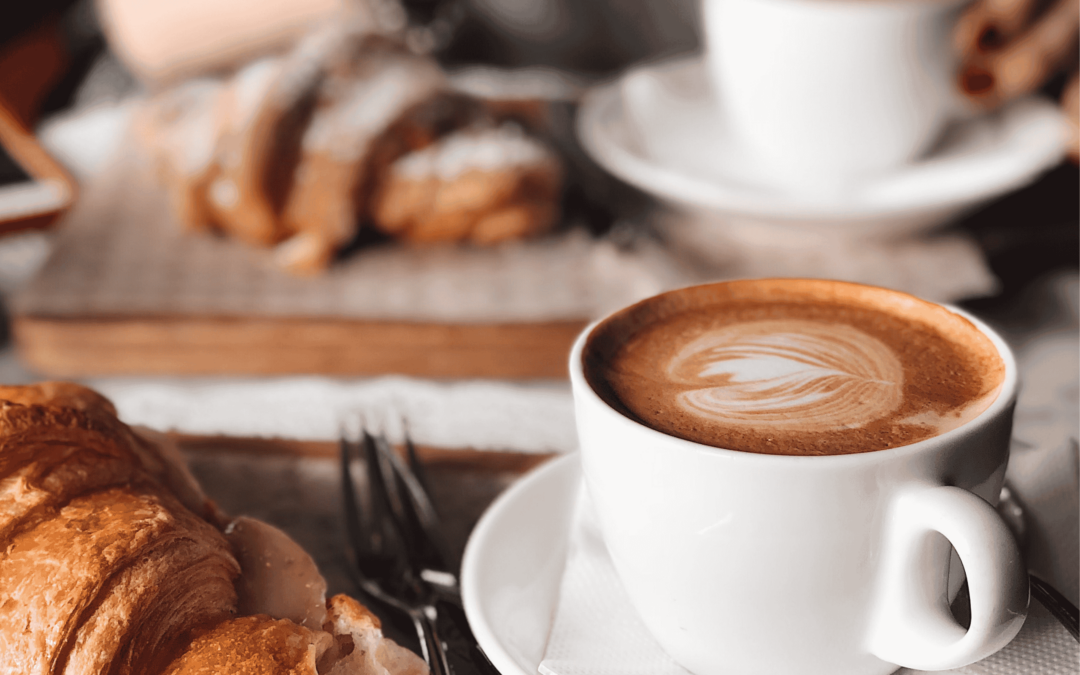 SEO for Hospitality Businesses - Image of a coffee and croissant in a cafe.