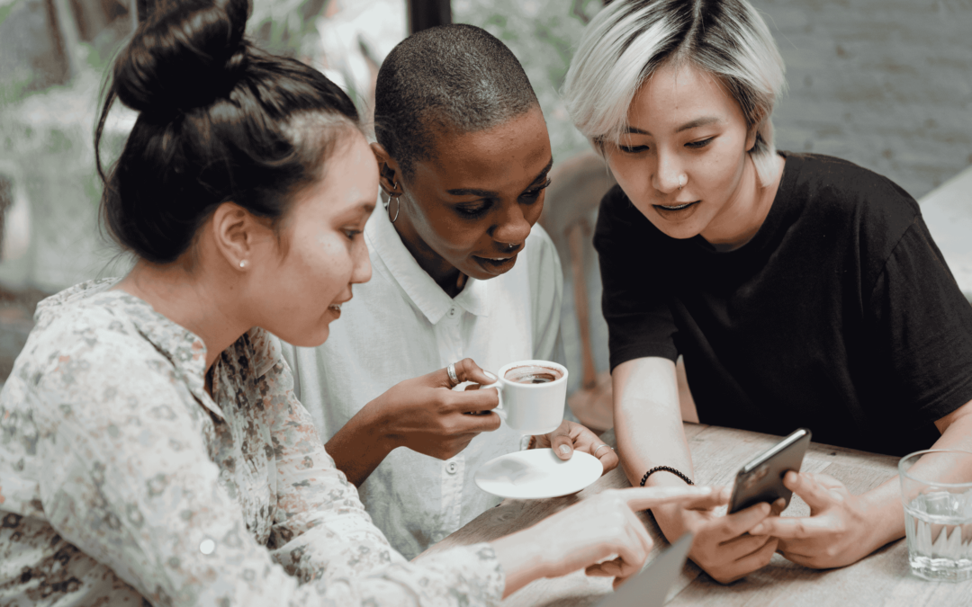 Social Media Marketing Agency - Image of three women looking at something on a phone.